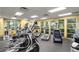 Well-lit fitness center featuring various cardio machines, weight equipment, and a mirrored wall for effective workouts at 4555 Sw 52Nd Cir # 103, Ocala, FL 34474