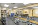 Community gym with weights, machines and mats, plus a wall mirror and view to the outside at 4555 Sw 52Nd Cir # 103, Ocala, FL 34474