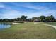 Scenic park with winding sidewalk, playground and basketball court alongside a tranquil lake at 4555 Sw 52Nd Cir # 103, Ocala, FL 34474