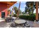 Exterior patio area featuring picnic tables for residents to use with overhead wooden beams and sun protection at 4555 Sw 52Nd Cir # 103, Ocala, FL 34474