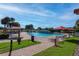 Resort-style community pool with umbrella-covered lounge chairs and lush landscaping at 4555 Sw 52Nd Cir # 103, Ocala, FL 34474