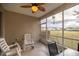 Inviting screened patio with tile flooring, ceiling fan, and comfortable seating to enjoy outdoor relaxation at 4555 Sw 52Nd Cir # 103, Ocala, FL 34474