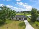 Aerial view of a one-story home with a long driveway and green lawn at 540 Nw 64Th Pl, Ocala, FL 34475