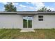 Close-up of the home's back sliding door and manicured lawn at 540 Nw 64Th Pl, Ocala, FL 34475