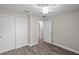 Bedroom with wood-look flooring, neutral walls, ceiling fan, and closet at 540 Nw 64Th Pl, Ocala, FL 34475