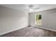 Bedroom features wood-look floors, neutral walls, ceiling fan, and window at 540 Nw 64Th Pl, Ocala, FL 34475