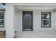 Close-up of the home's front door, flanked by windows at 540 Nw 64Th Pl, Ocala, FL 34475