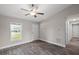 Bright living room featuring wood-look floors, a ceiling fan, and natural light at 540 Nw 64Th Pl, Ocala, FL 34475