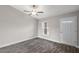 Inviting living room showcasing wood-look floors, a ceiling fan, and a large window at 540 Nw 64Th Pl, Ocala, FL 34475