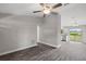 Open-concept living room with wood-look floors, neutral walls, and a view to the kitchen at 540 Nw 64Th Pl, Ocala, FL 34475