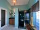 Bright bathroom with a dark glass shower, wood vanity, and transom window at 5500 Nw 23Rd Pl, Ocala, FL 34482