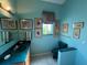 Aqua bathroom featuring a sink, toilet, and artwork hanging on the walls at 5500 Nw 23Rd Pl, Ocala, FL 34482