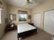 A simple bedroom featuring a queen mattress, ceiling fan, and a double closet at 5500 Nw 23Rd Pl, Ocala, FL 34482