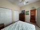 Bedroom featuring a queen mattress, ceiling fan, double closets, and a chest of drawers at 5500 Nw 23Rd Pl, Ocala, FL 34482