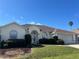 Charming single-story home featuring a well-manicured lawn, neutral tones, and attached two car garage at 5500 Nw 23Rd Pl, Ocala, FL 34482