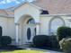 Inviting front entrance with double doors, arched entryway and manicured landscaping at 5500 Nw 23Rd Pl, Ocala, FL 34482