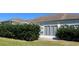 Enclosed back patio and yard featuring mature privacy hedges at 5500 Nw 23Rd Pl, Ocala, FL 34482