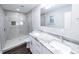 Bright bathroom featuring double sinks, granite counters and a frameless glass shower at 5526 Se 170Th Ct, Ocklawaha, FL 32179