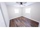 Clean, minimal bedroom with a window and ceiling fan, over wood-look flooring at 5526 Se 170Th Ct, Ocklawaha, FL 32179