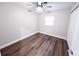 Clean, minimal bedroom with a closet, window and ceiling fan, over wood-look flooring at 5526 Se 170Th Ct, Ocklawaha, FL 32179