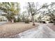 Long, curved driveway leading to the house surrounded by mature trees at 5526 Se 170Th Ct, Ocklawaha, FL 32179