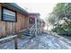 Sunlit exterior view of a home with wood siding, stairs, and lattice at 5526 Se 170Th Ct, Ocklawaha, FL 32179