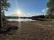 Beautiful lake view with a dock, captured on a sunny day with reflections on the water at 5526 Se 170Th Ct, Ocklawaha, FL 32179