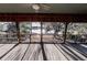 Inviting wooden screened porch with a view of the lake, perfect for relaxing and enjoying nature at 5526 Se 170Th Ct, Ocklawaha, FL 32179