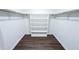 Walk-in closet with custom shelving providing ample storage and organization with hardwood flooring at 5526 Se 170Th Ct, Ocklawaha, FL 32179