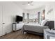 Bedroom featuring large windows, gray furniture, and light walls at 5728 Sw 90Th Court Rd, Ocala, FL 34481