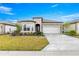 Beautiful front exterior featuring stone accents, a well-manicured lawn and an eye catching driveway at 5728 Sw 90Th Court Rd, Ocala, FL 34481