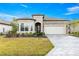 Beautiful front exterior featuring stone accents, a well-manicured lawn and an eye catching driveway at 5728 Sw 90Th Court Rd, Ocala, FL 34481