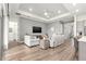 Open-concept living room featuring a tray ceiling, recessed lighting, and wood-look flooring throughout at 5728 Sw 90Th Court Rd, Ocala, FL 34481