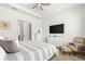 Bedroom featuring a tray ceiling, recessed lighting, a TV, and a comfy chair for lounging at 5728 Sw 90Th Court Rd, Ocala, FL 34481