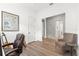 A seating area in a home office features wood flooring, and a neutral color scheme at 5728 Sw 90Th Court Rd, Ocala, FL 34481