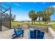 Cozy patio featuring a stone fire pit and Adirondack chairs, ideal for outdoor gatherings and relaxation at 5728 Sw 90Th Court Rd, Ocala, FL 34481