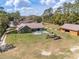 Aerial view of home with backyard playground, green lawn, pool and detached garage at 5995 Se 22Nd Ave, Ocala, FL 34480