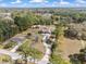 Beautiful aerial view of home with winding driveway, surrounded by mature trees and well-maintained grounds at 5995 Se 22Nd Ave, Ocala, FL 34480