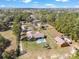 An aerial view of a home featuring an in-ground pool, playground and orange outbuilding at 5995 Se 22Nd Ave, Ocala, FL 34480