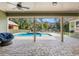 Covered patio with ceiling fans overlooking the backyard pool and play area at 5995 Se 22Nd Ave, Ocala, FL 34480