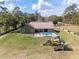 Gorgeous aerial view of the backyard featuring a swimming pool and playground at 5995 Se 22Nd Ave, Ocala, FL 34480