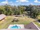 Aerial view of large backyard with playset and in-ground pool and metal roofed buildings at 5995 Se 22Nd Ave, Ocala, FL 34480