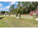 Expansive backyard showcasing the outbuilding with a retaining wall and lush greenery at 5995 Se 22Nd Ave, Ocala, FL 34480