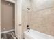 Bathroom with tiled shower and tub showcasing neutral colors and modern fixtures at 5995 Se 22Nd Ave, Ocala, FL 34480