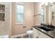 Bathroom vanity with granite countertops, custom cabinets and tiled shower with glass window at 5995 Se 22Nd Ave, Ocala, FL 34480