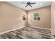 Bedroom with hardwood floors, ceiling fan and natural light from two windows at 5995 Se 22Nd Ave, Ocala, FL 34480