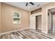 Bedroom featuring hardwood floors, ceiling fan, closet and natural light from the window at 5995 Se 22Nd Ave, Ocala, FL 34480