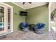 Cozy covered patio with lounge seating and wall-mounted TV at 5995 Se 22Nd Ave, Ocala, FL 34480