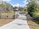 Elegant driveway gate with stone pillars, enhancing curb appeal and security at 5995 Se 22Nd Ave, Ocala, FL 34480