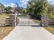 Front entrance gate, featuring stone pillars and an automatic gate opener at 5995 Se 22Nd Ave, Ocala, FL 34480